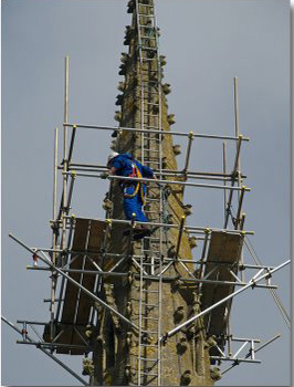 Steeplejack working on old church